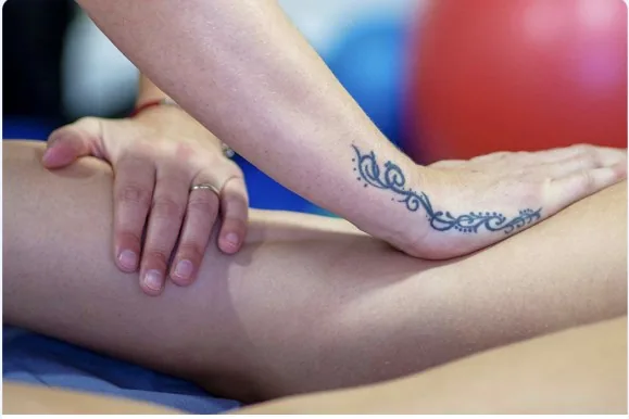 Sports massage being applied to a client's calf